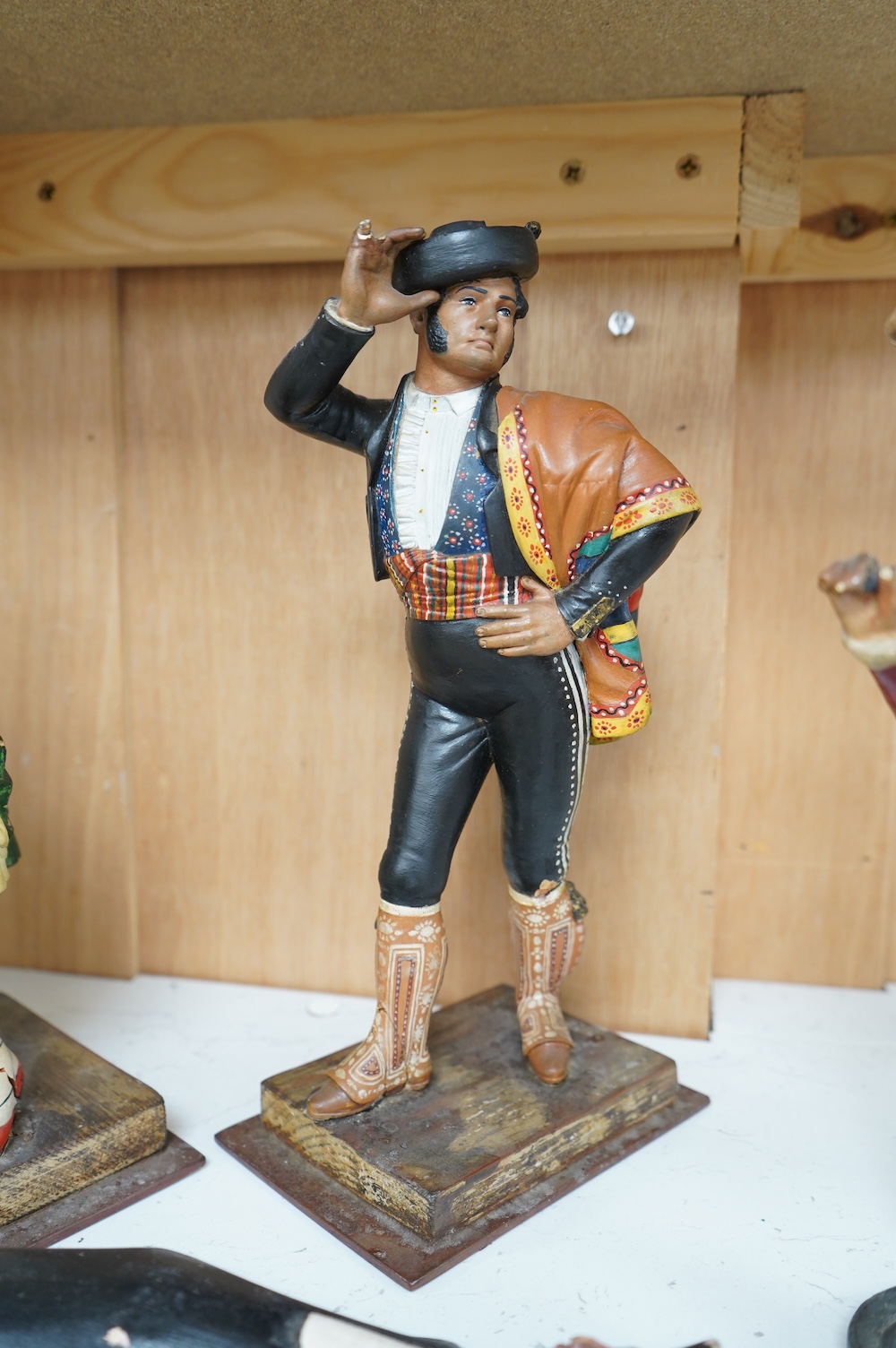 A Johnnie Walker advertising figure, two models of Spanish dancers and an Indian figural carving, tallest 30cm. Condition - poor